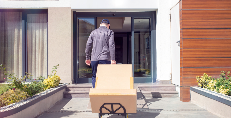 Delivery person using dolly to deliver big and bulky packages.