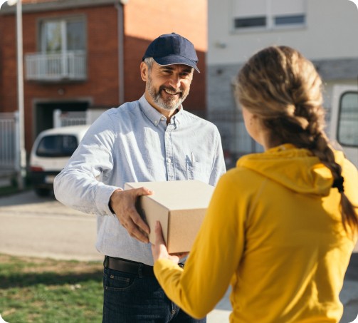Delivery of oversized items with person using hand truck.