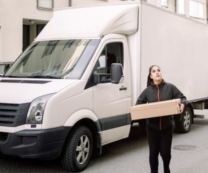 female delivery driver delivering package to business
